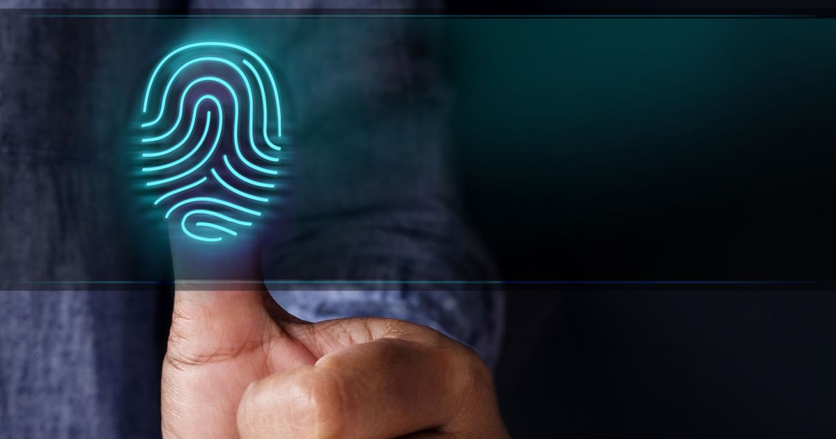 A person holding a finger displaying a clear fingerprint for examination or identification purposes.