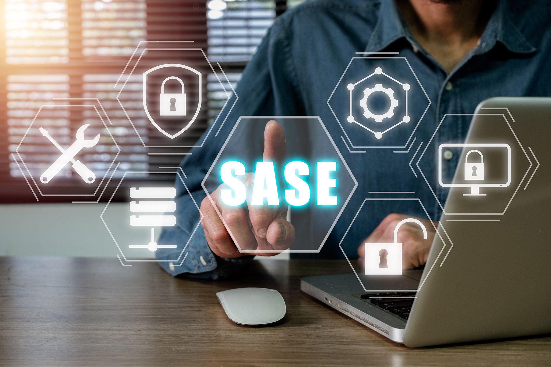 Person using a laptop and pointing to SASE icons.