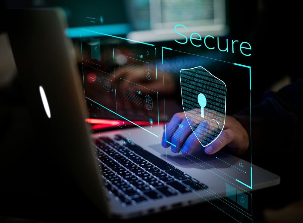 Close-up of a person working on a laptop, featuring a security concept, highlighting cybersecurity awareness.
