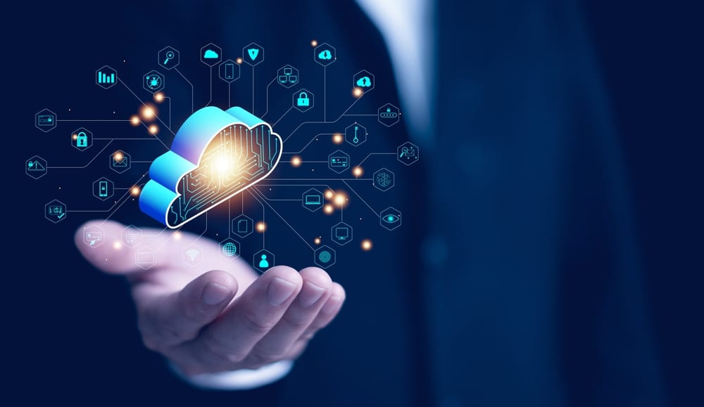 Person holding a cloud icon in their palms, symbolizing the importance of maximizing cloud technology.
