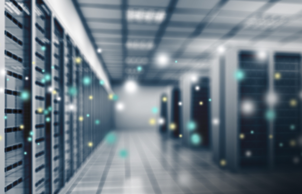 A server room filled with numerous servers and illuminated by various lights, showcasing a high-tech environment.