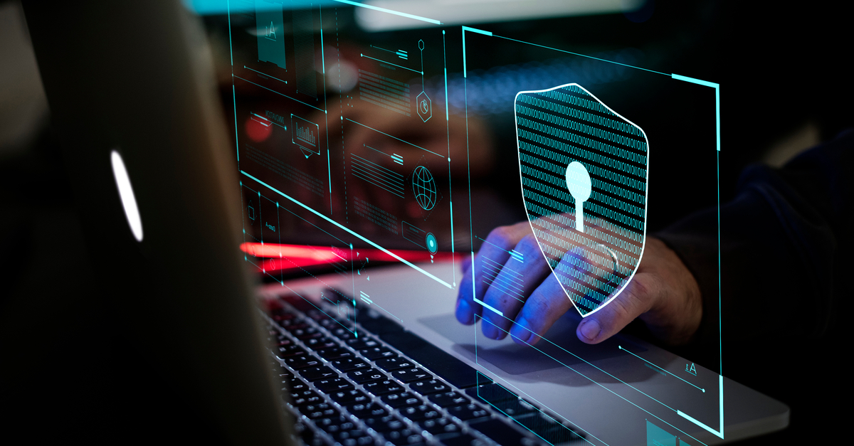 A person's hands are typing on a laptop keyboard, with a security lock icon overlaying the image for emphasis on security.