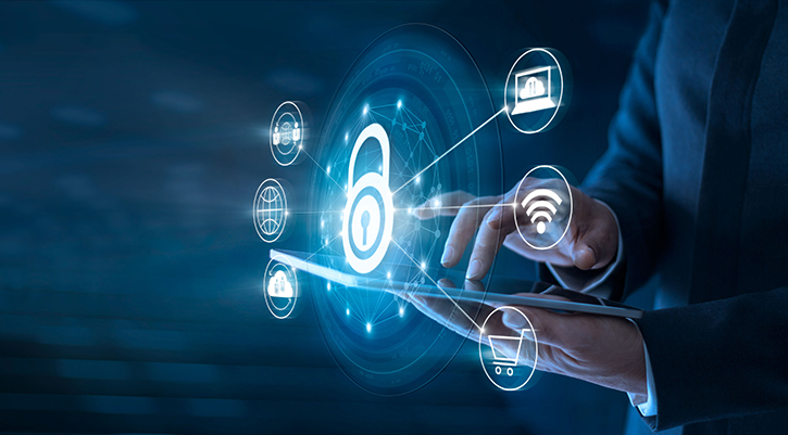 A man dressed in a suit is holding a tablet that shows several icons, with a padlock icon highlighted.
