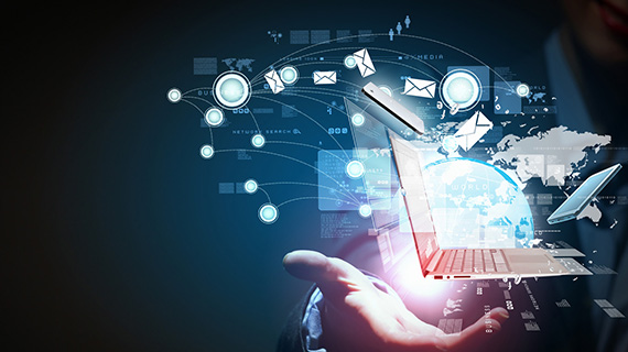 A person holds a laptop displaying various icons, symbolizing digital tools and applications.