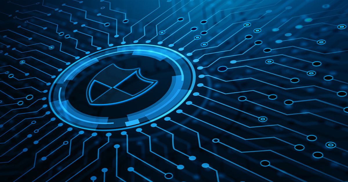 A shield icon overlaid on a circuit board, set against a blue background, symbolizing cybersecurity and technology.