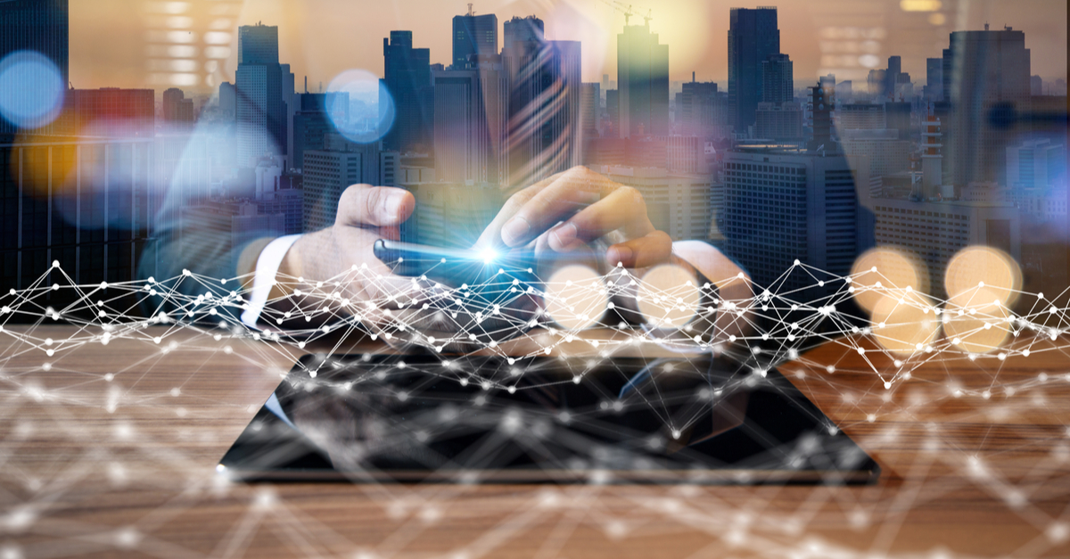 Businessman using a phone, connected to a network, with a cityscape visible in the background.
