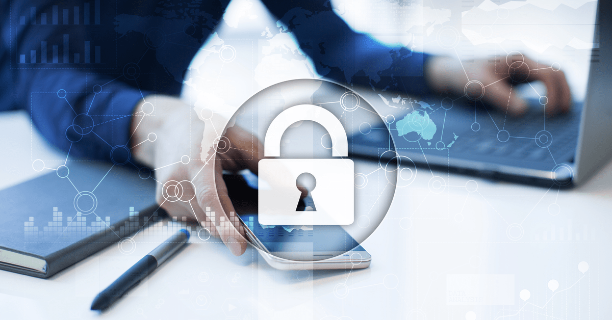 A businessman focused on his laptop, which shows a padlock icon, indicating secure online activity.