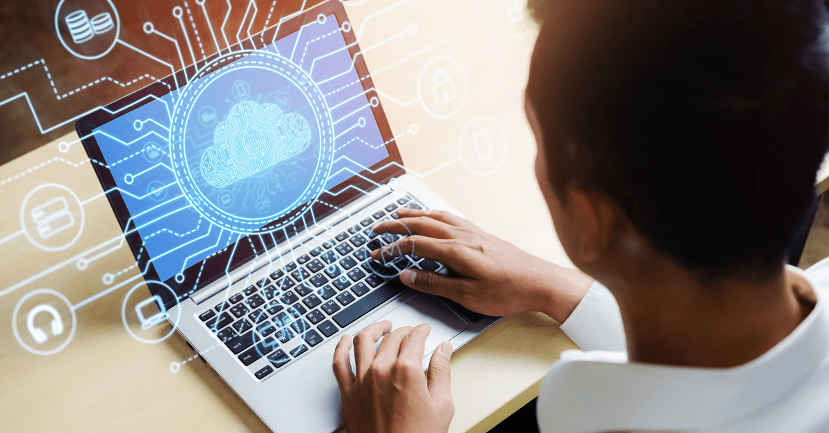 Man working on a laptop displaying cloud computing icons on the screen, illustrating digital technology and connectivity.