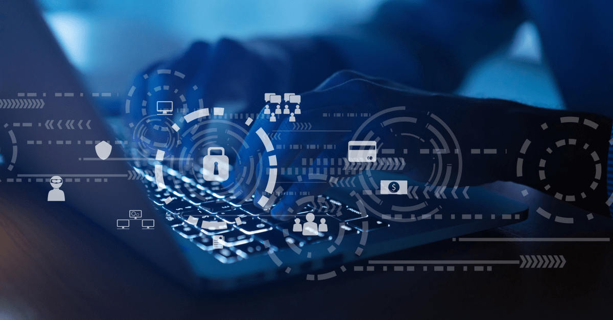 Professional typing on a laptop, emphasizing ways to defend a business from cyber attacks.