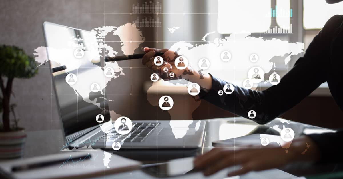 Businesswoman typing on a laptop, with various social media icons illustrating her digital communication efforts.