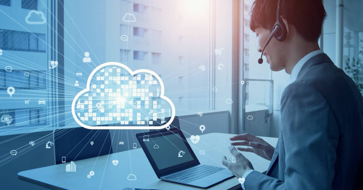 A man working intently on a laptop, featuring a cloud computing icon, representing modern technology and remote access.