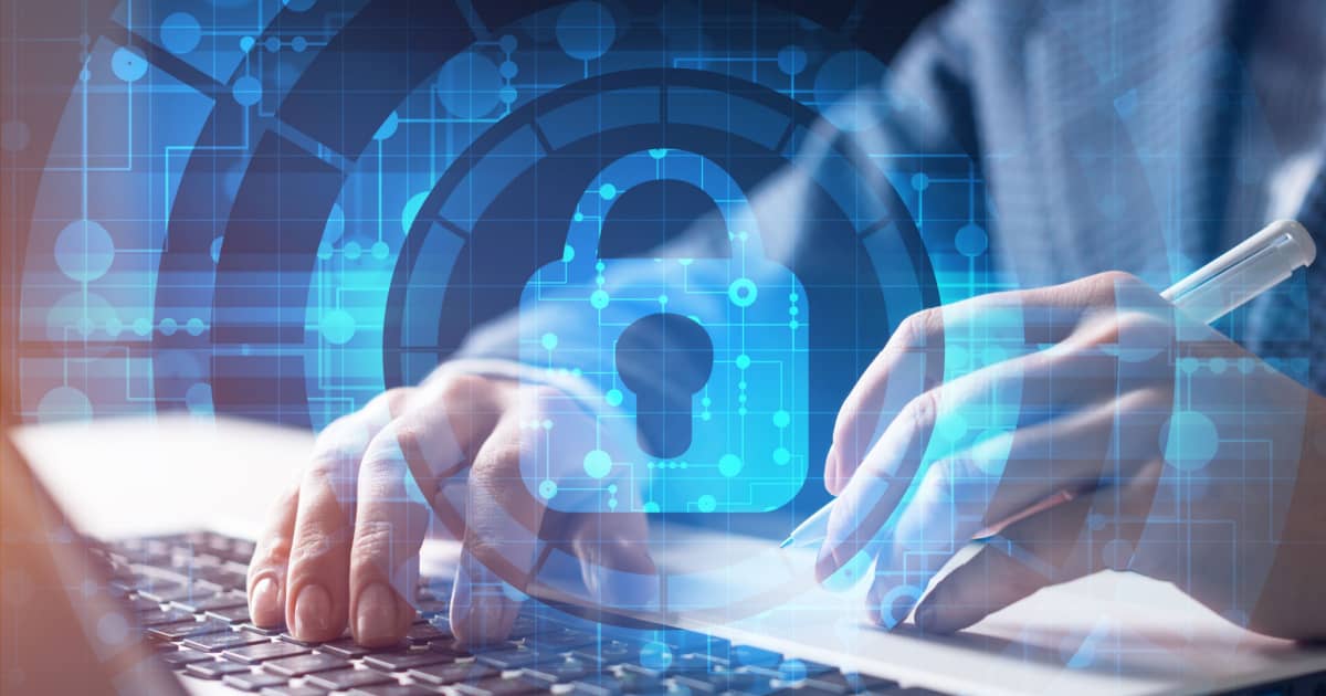 Businessman working on a laptop displaying a padlock icon, symbolizing security and data protection.