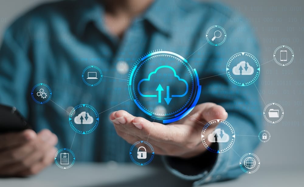 A man shows cloud computing icons on the screen, representing modern technology and digital solutions.