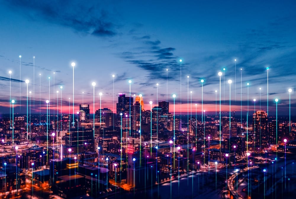 A night view of Minneapolis, featuring the city illuminated by glowing dots.